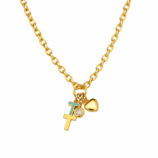 A gold chain necklace featuring a cross pendant with a turquoise enamel 'I' and a small clear stone, alongside a gold heart charm, shown on a plain white background.