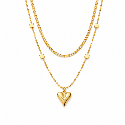 Gold heart-shaped pendant necklace on a white background