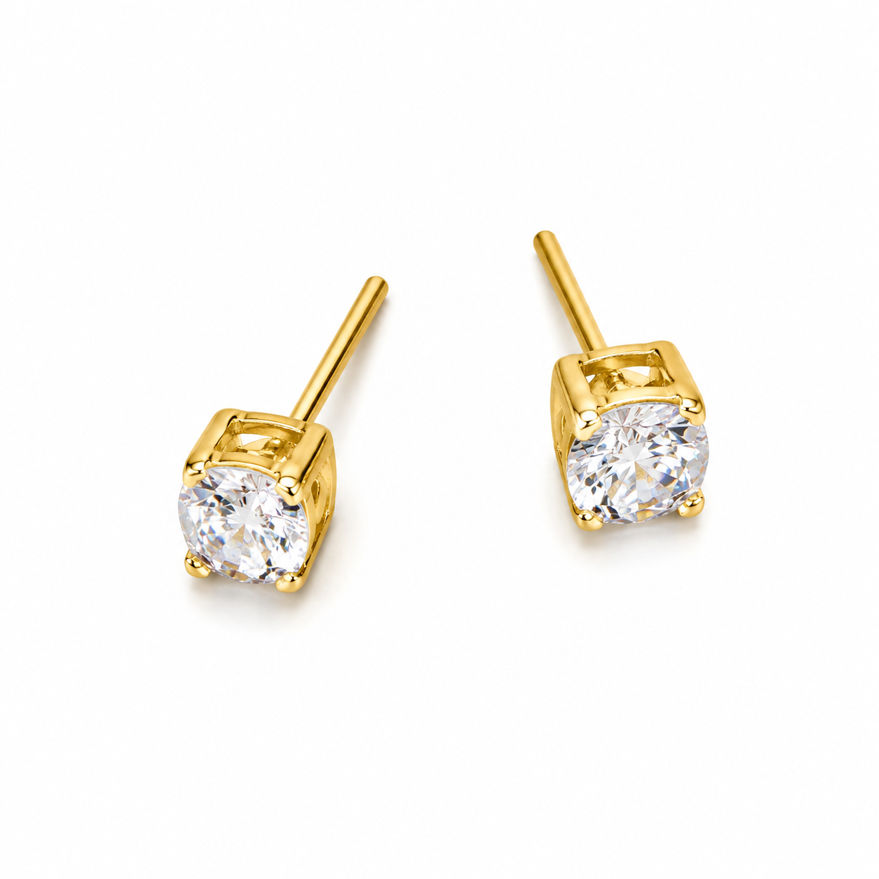 Gold stud earrings with clear gemstones on a white background