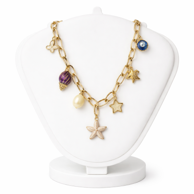 Gold necklace with starfish and pearl charms on a white stand