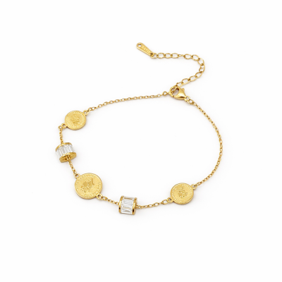 Gold bracelet with small round charms on a white background
