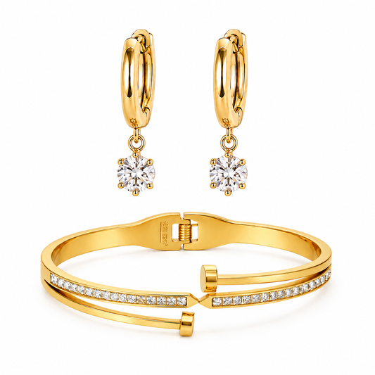 Gold hoop earrings with diamond drops and a gold bracelet on a white background