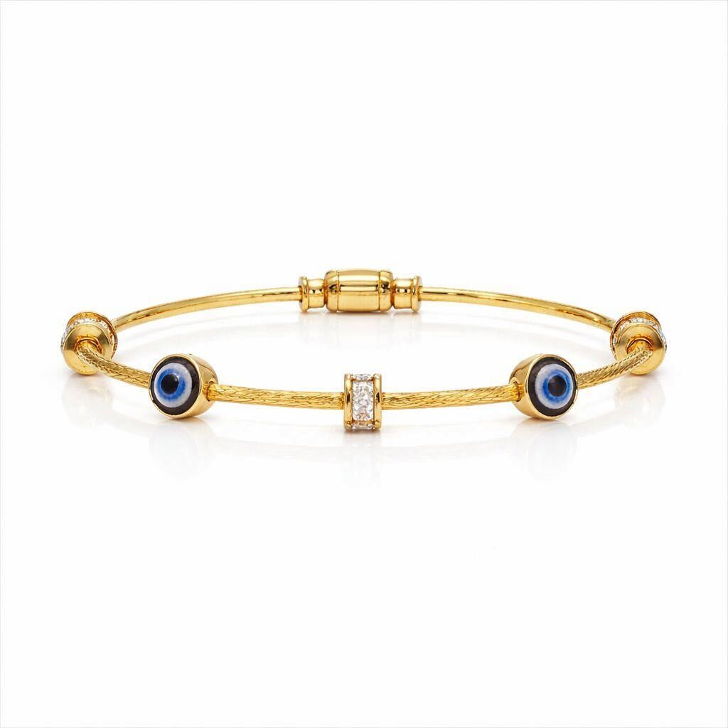Gold bracelet with blue evil eye charms on a white background