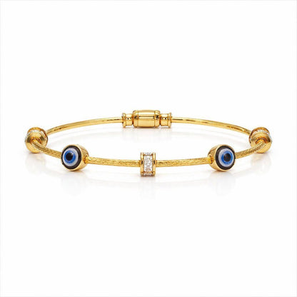 Gold bracelet with blue evil eye charms on a white background