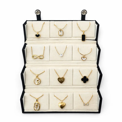 Jewelry display with various necklaces on a white background