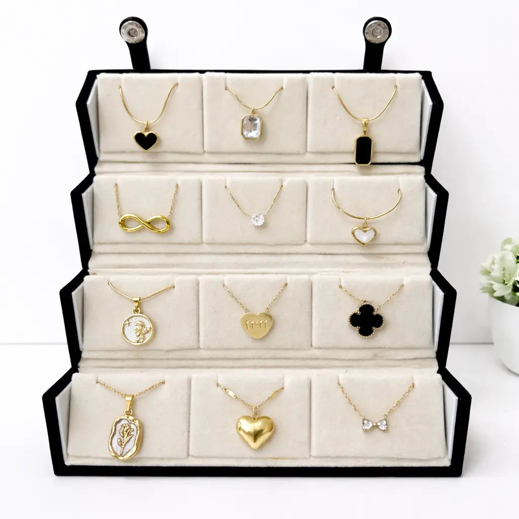 Display of various gold necklaces with pendants on a white background