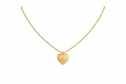 A delicate gold chain necklace with a small heart-shaped pendant engraved with the date '11.11', displayed on a clean white background.