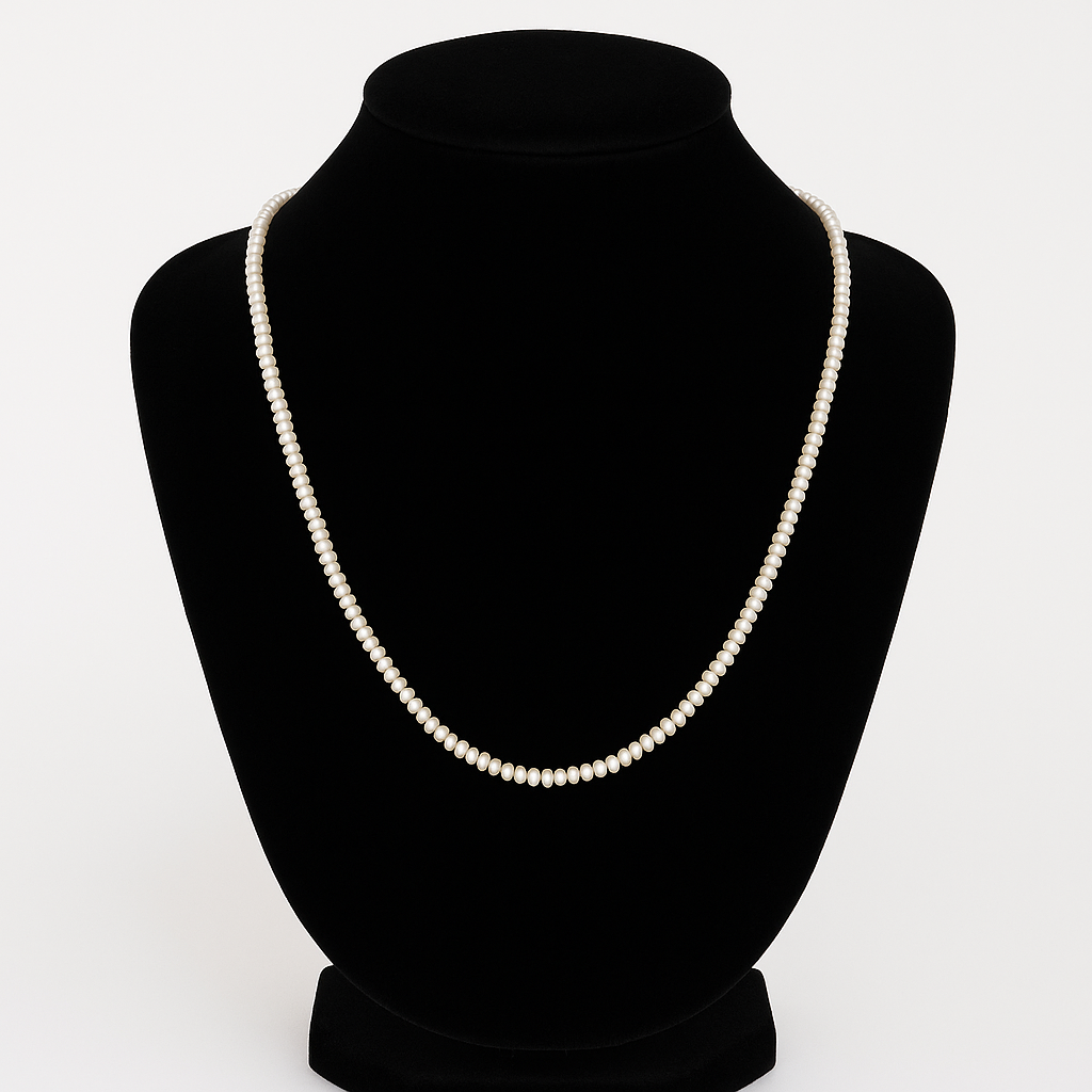 Pearl necklace on a black mannequin bust against a white background

