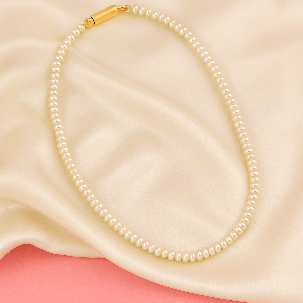 Pearl necklace with a gold clasp on a soft fabric background

