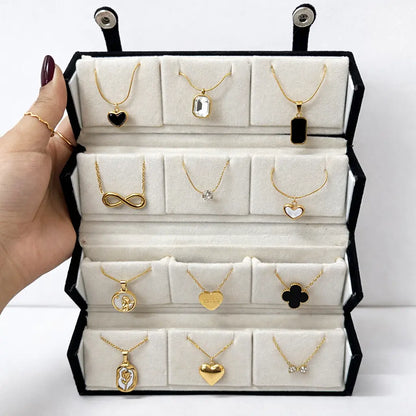 Jewelry display case with gold necklaces on a white background