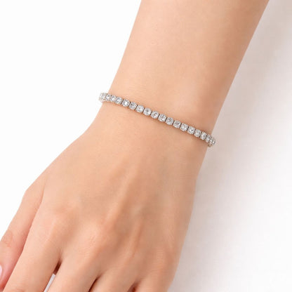 Silver bracelet with clear stones on a wrist against a white background

