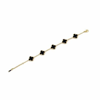 Gold bracelet with black clover-shaped charms on a white background