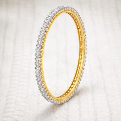 Gold and silver bracelet on a light gray background