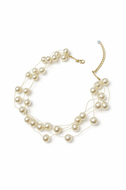 Pearl necklace with gold chain on a white background