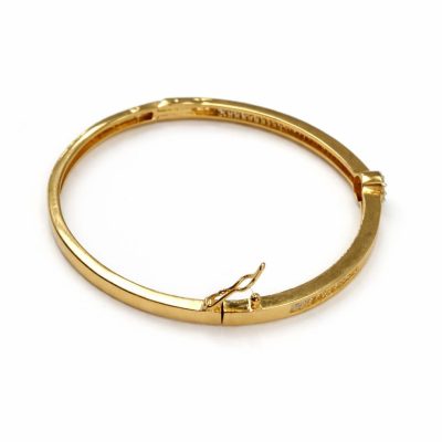 Gold bracelet on a white background
