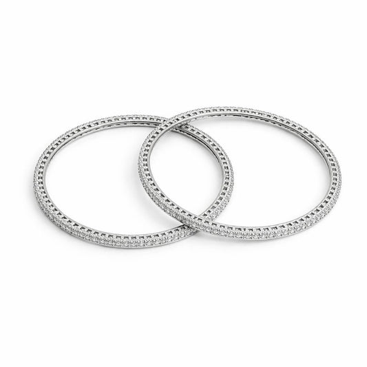 Two silver bangles with diamond accents on a white background