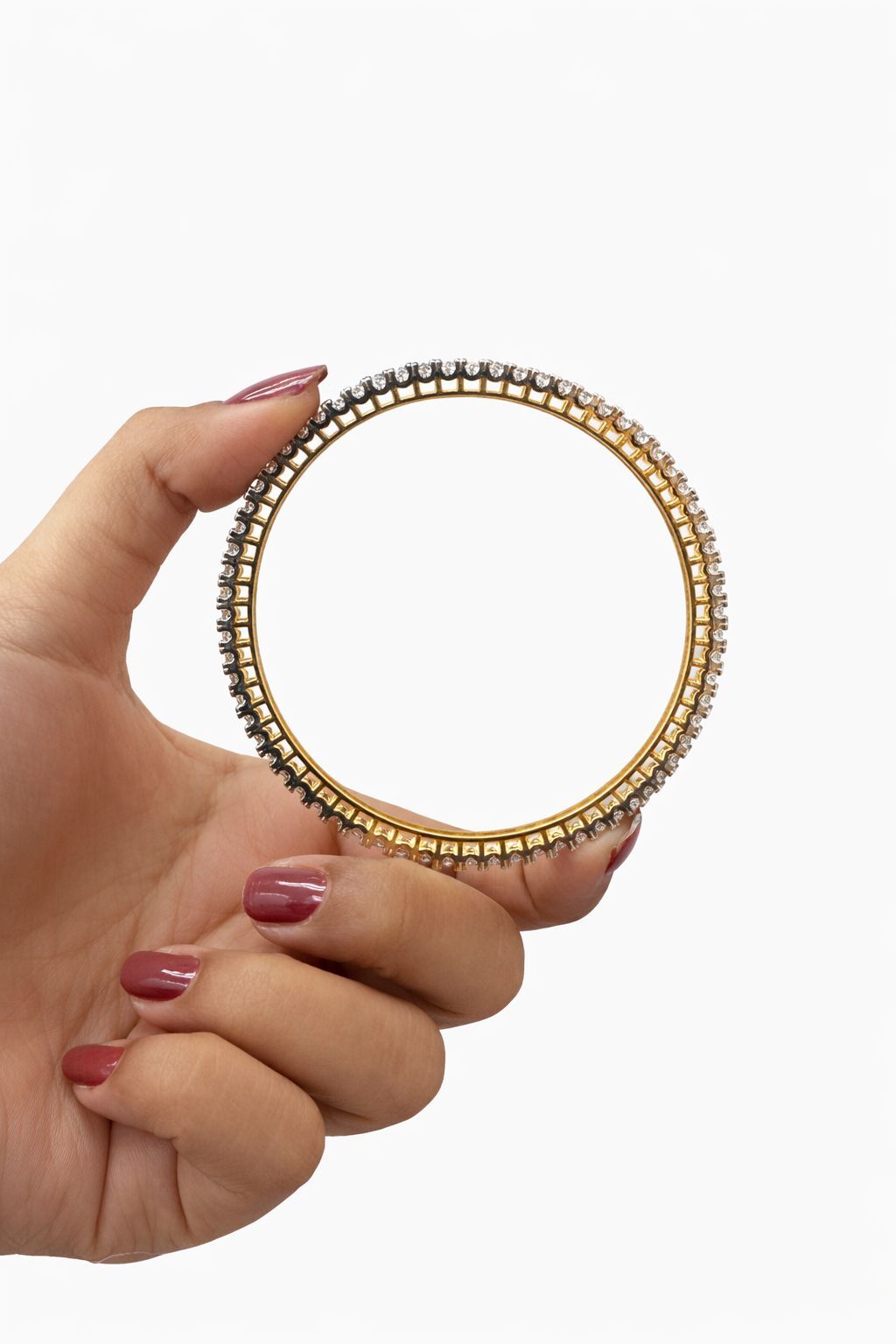 Hand holding a gold and silver beaded ring against a white background