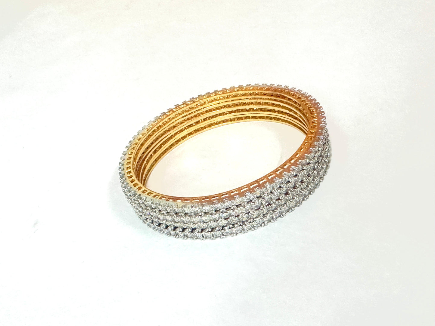 Set of gold and silver bangles on a white background