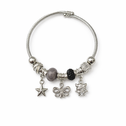 Silver charm bracelet with various charms on a white background